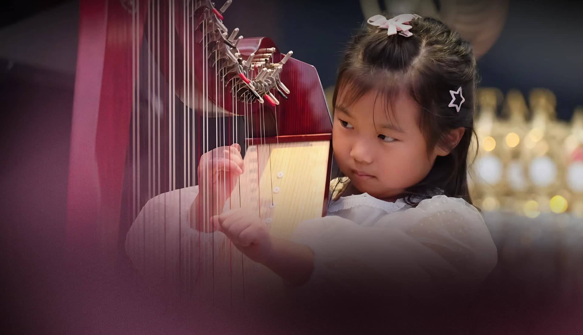 A young harpist performing at Gold Star Music Festival