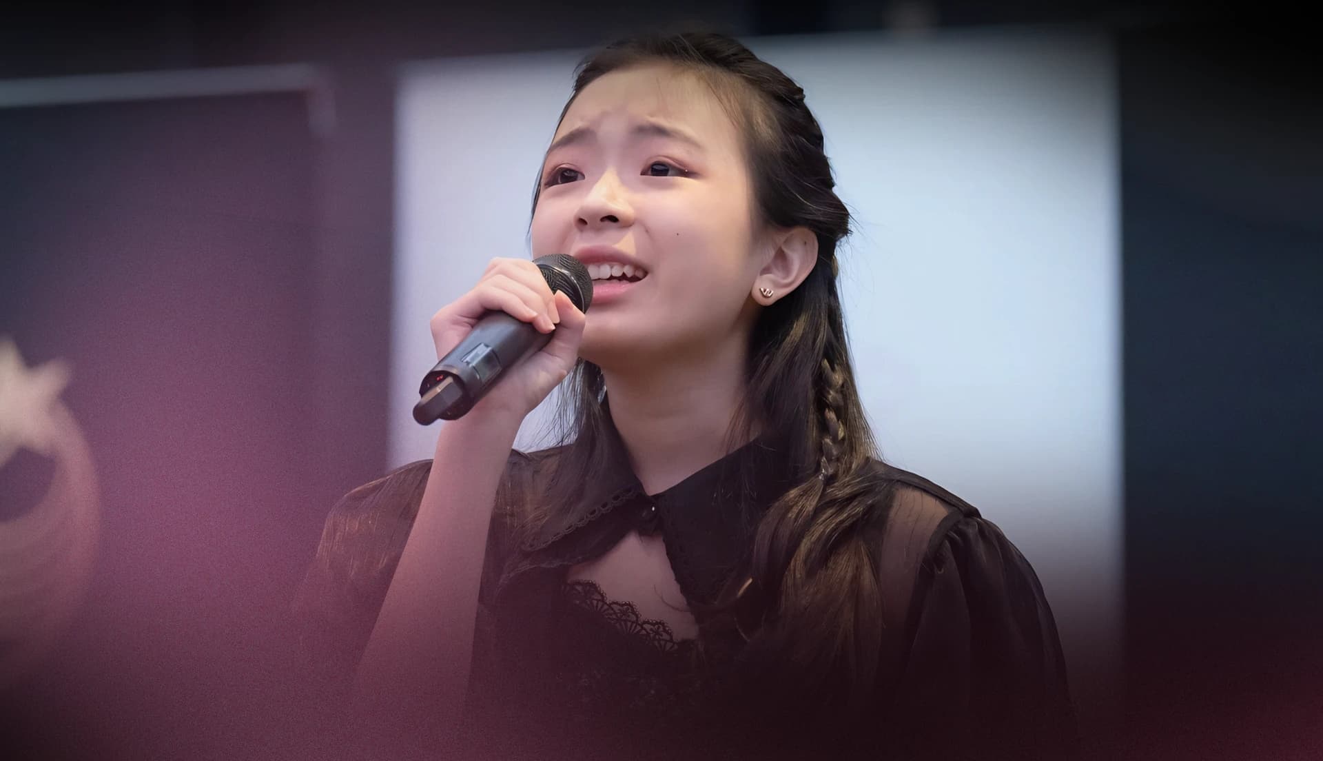 A young vocalist performing at Gold Star Music Festival
