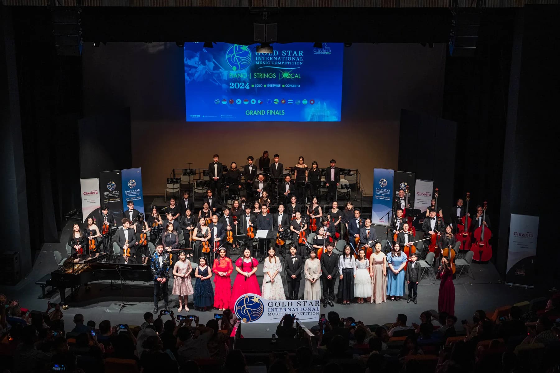 Performers and orchestra gather on the 2024 Competition stage