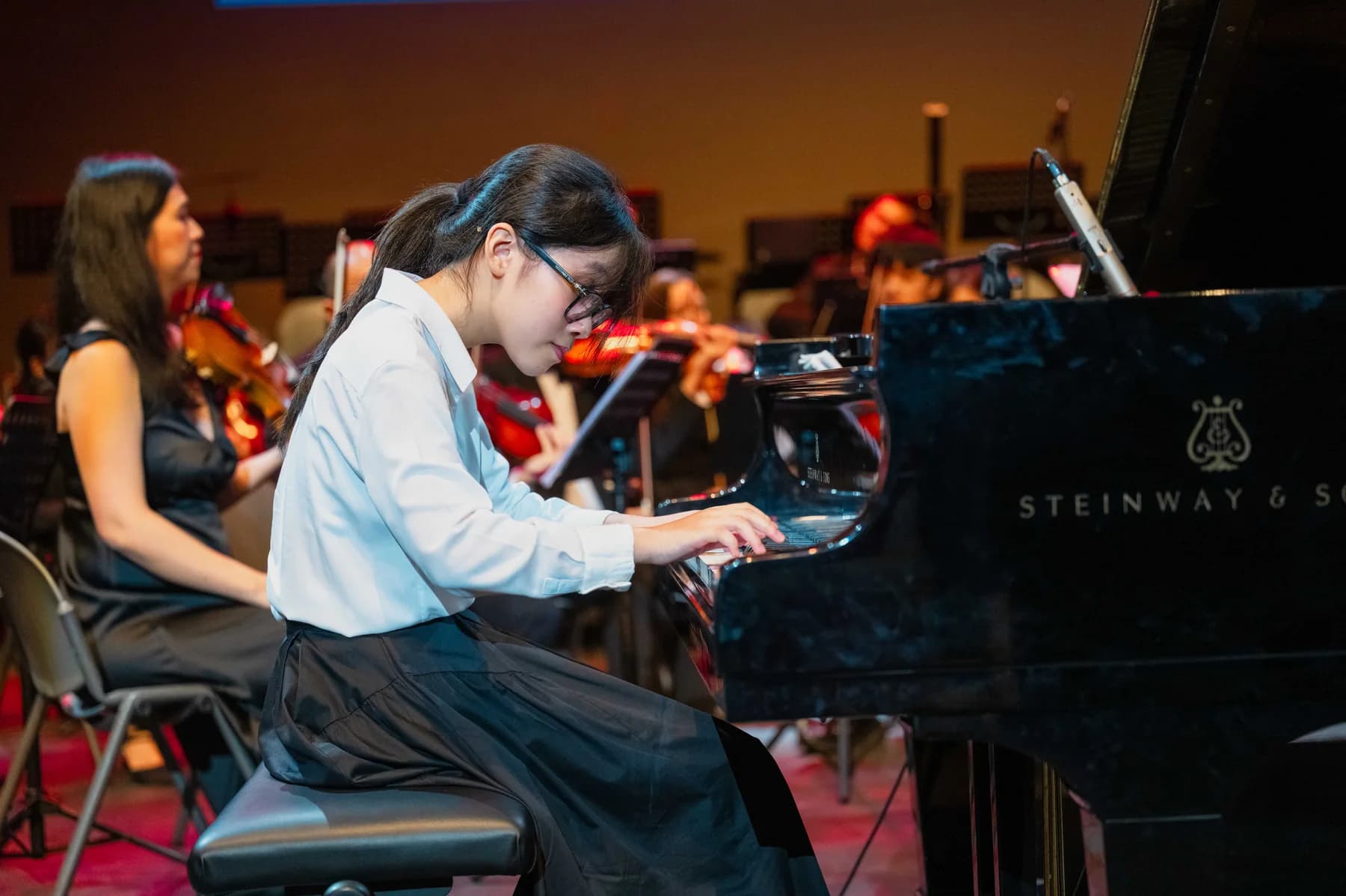 A pianist performs with an orchestra during the 2024 Competition programme