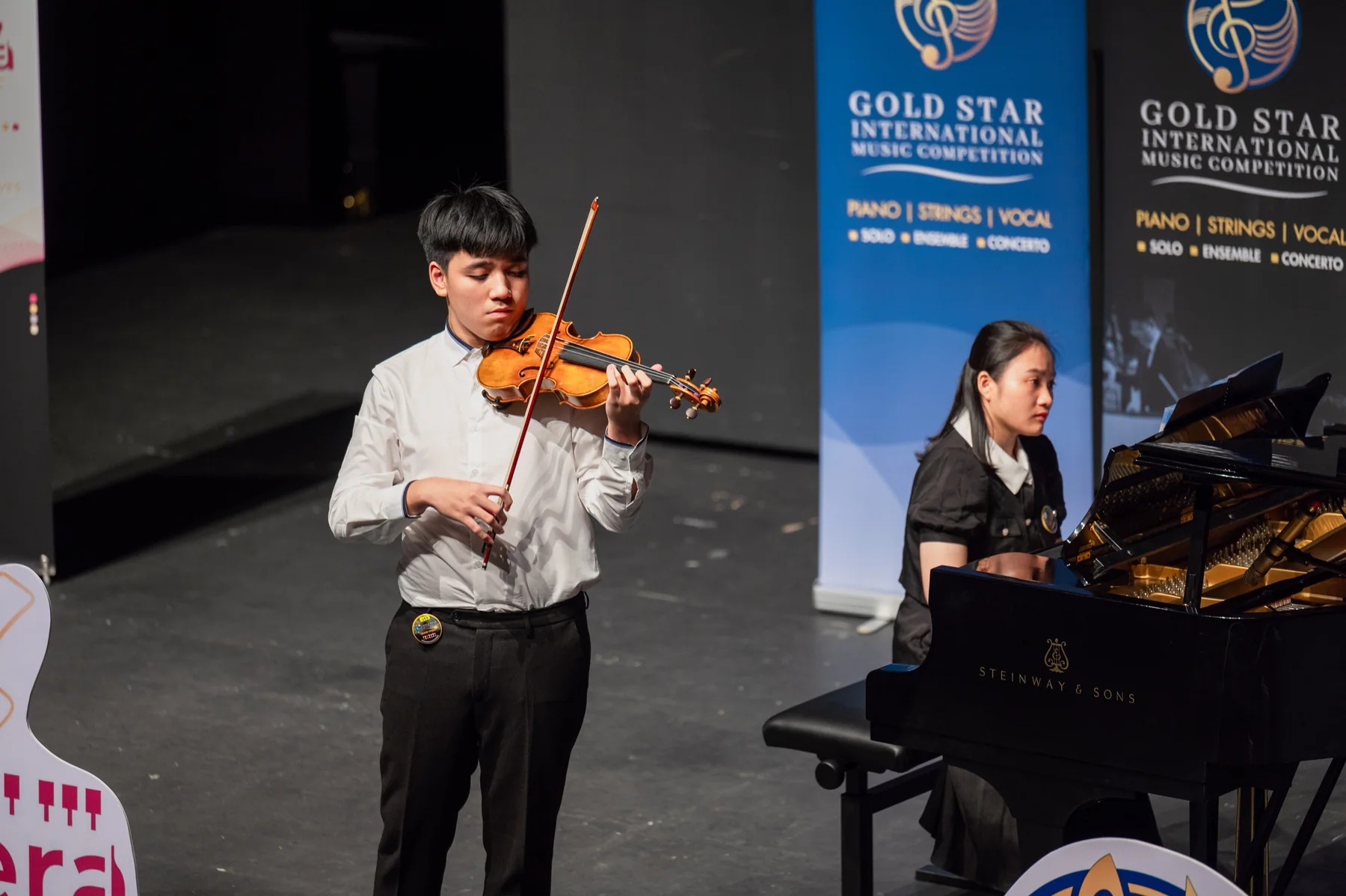 A violinist performs with piano accompaniment at the 2024 Competition