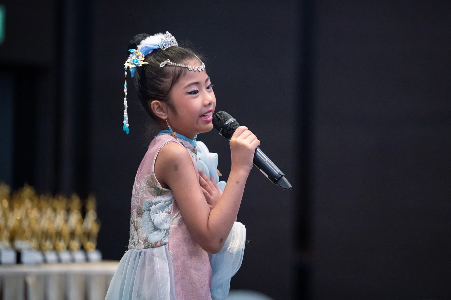 A young vocalist sings at Gold Star Music Festival 2023