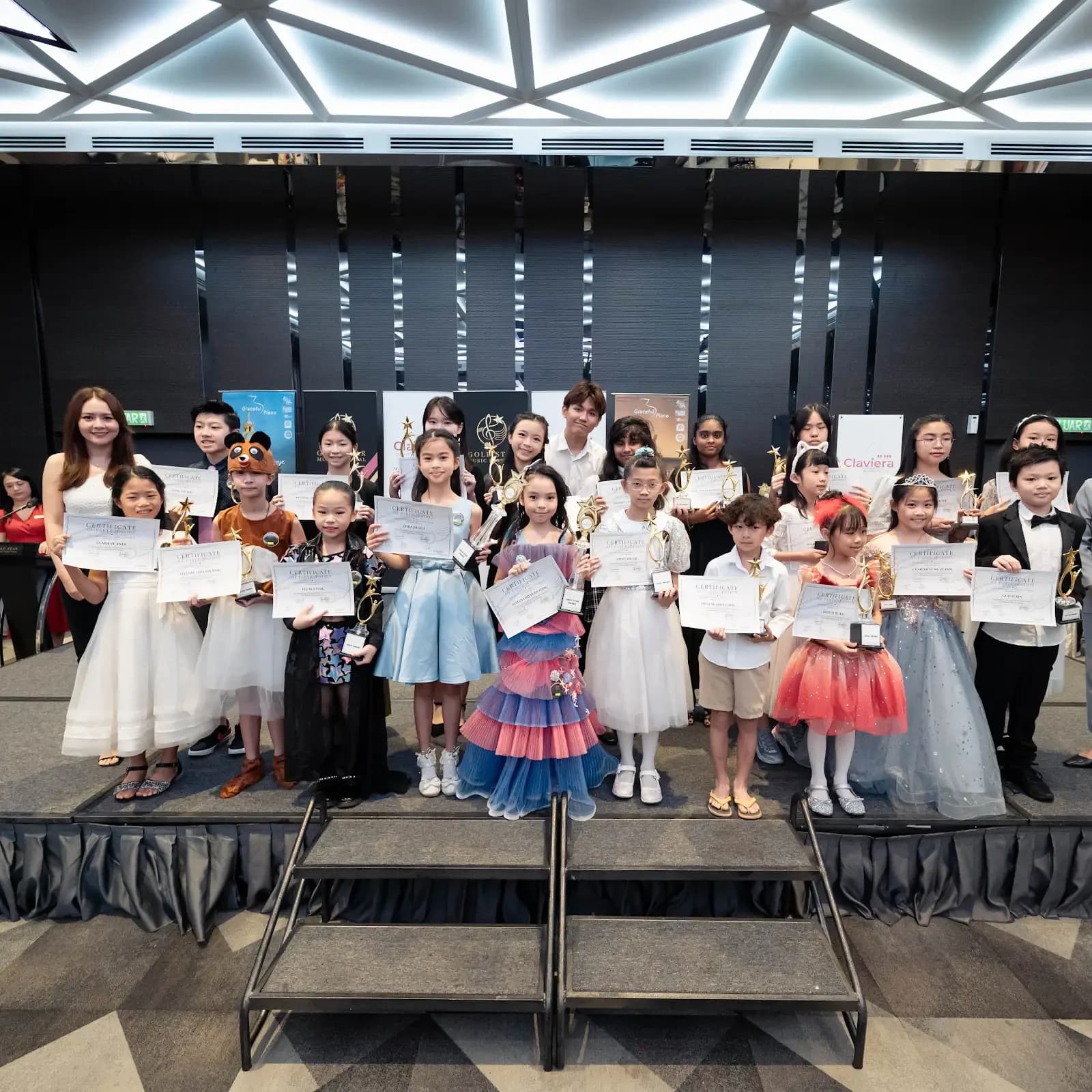Young Gold Star Music Festival performers celebrate together on the 2023 stage